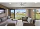 Spacious lanai with serene lake view, comfortable seating, and modern ceiling fans at 1581 Rowell St, The Villages, FL 34762