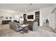 Open-concept living area with tile flooring, stylish furniture, and abundant natural light at 1581 Rowell St, The Villages, FL 34762