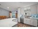 Bright kitchen featuring white cabinetry, stainless steel appliances, tile backsplash and island at 16840 Se 97Th Wildwood Ct, The Villages, FL 32162