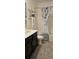 Well-lit bathroom featuring modern fixtures and a shower with a stylish curtain at 1723 Happiness Row, Kissimmee, FL 34744