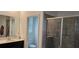 Bathroom with shower and glass door and granite countertops at 1723 Happiness Row, Kissimmee, FL 34744
