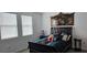 Bedroom with two sunny windows, dark furniture, and unique decorative headboard art at 1723 Happiness Row, Kissimmee, FL 34744