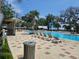 Large community pool with tanning chairs, water slide feature and shaded pool house at 1723 Happiness Row, Kissimmee, FL 34744
