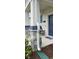 Detailed view of the front porch columns and seating area at 1723 Happiness Row, Kissimmee, FL 34744