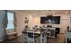 Kitchen with a dark wood table, light colored chairs, dark cabinets, stainless steel appliances, and hardwood floors at 1723 Happiness Row, Kissimmee, FL 34744