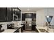 Close up of modern kitchen featuring dark wood cabinets, stainless steel appliances, and white countertops and backsplash at 1723 Happiness Row, Kissimmee, FL 34744