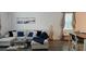 Living room featuring hardwood floors, a large sectional sofa, and contemporary decor creating a cozy and inviting atmosphere at 1723 Happiness Row, Kissimmee, FL 34744