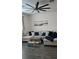 Living room featuring hardwood floors, a large sectional sofa, and contemporary decor creating a cozy and inviting atmosphere at 1723 Happiness Row, Kissimmee, FL 34744