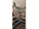 Walk-in pantry with shelves filled with food and drinks, offering ample storage space at 1723 Happiness Row, Kissimmee, FL 34744