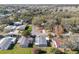 Aerial view of a neighborhood with mature trees, well-kept lawns and quaint streets at 1727 Hilton Head Blvd, Lady Lake, FL 32159