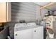 Functional laundry room with a washer, dryer, and storage shelves at 1727 Hilton Head Blvd, Lady Lake, FL 32159