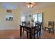 Well-lit dining area with a wooden table, adjacent to a kitchen at 17490 Se 110Th Ter, Summerfield, FL 34491