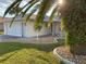 Charming single-story home with decorative stone features and a paver driveway surrounded by mature landscaping at 17490 Se 110Th Ter, Summerfield, FL 34491