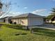 Attached two-car garage with lush green lawn, driveway and mature landscaping at 17490 Se 110Th Ter, Summerfield, FL 34491