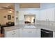 Bright kitchen with white cabinets, granite counters, and stylish backsplash, offering both functionality and appeal at 17490 Se 110Th Ter, Summerfield, FL 34491