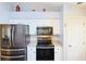 A bright kitchen is equipped with stainless steel appliances, decorative backsplash and white cabinetry at 17490 Se 110Th Ter, Summerfield, FL 34491
