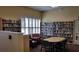 A community library featuring bookshelves, large windows, a table, and comfortable seating at 17490 Se 110Th Ter, Summerfield, FL 34491