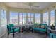Bright glass-enclosed patio with tile floors and an inviting seating arrangement at 17490 Se 110Th Ter, Summerfield, FL 34491