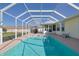 Inviting pool with screened enclosure and outdoor space at 17490 Se 110Th Ter, Summerfield, FL 34491