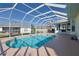 Inviting pool with screened enclosure and outdoor space at 17490 Se 110Th Ter, Summerfield, FL 34491