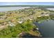 Extensive aerial view showcasing a large, Primary-planned community on a lake with a golf course at 17648 Live Oak Dr, Tavares, FL 32778