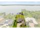 Aerial view of a lakefront home with outlined property lines, private dock and lush green surroundings at 17648 Live Oak Dr, Tavares, FL 32778