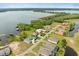 Aerial view showcasing luxury homes on a serene lake, featuring private docks and beautifully landscaped yards at 17648 Live Oak Dr, Tavares, FL 32778