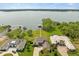 Aerial view of luxury homes along the lake with private docks, lush landscaping, and stunning waterfront views at 17648 Live Oak Dr, Tavares, FL 32778