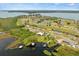 Aerial view of the community showing a golf course, several homes, and lakefront property at 17648 Live Oak Dr, Tavares, FL 32778