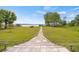 Expansive backyard featuring a stone path leading to a covered dock on the waterfront at 17648 Live Oak Dr, Tavares, FL 32778