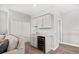 Modern bar area featuring a sleek beverage fridge, sink, and upper cabinets at 17648 Live Oak Dr, Tavares, FL 32778