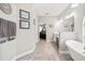 Hallway leading to bathroom with soaking tub, walk-in shower, and double vanity sinks at 17648 Live Oak Dr, Tavares, FL 32778