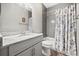 Bathroom featuring a gray tiled shower with a floral shower curtain and vanity with granite countertop at 17648 Live Oak Dr, Tavares, FL 32778