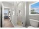 Bright bathroom features a glass enclosed shower and a window to provide natural lighting at 17648 Live Oak Dr, Tavares, FL 32778