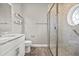 Modern bathroom with a glass walk-in shower, and a granite top vanity with modern sink at 17648 Live Oak Dr, Tavares, FL 32778