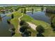 Scenic golf course view featuring lush green fairways, water features, and mature trees, creating a picturesque landscape at 17648 Live Oak Dr, Tavares, FL 32778