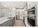 Modern kitchen featuring stainless steel appliances and a central island at 17648 Live Oak Dr, Tavares, FL 32778