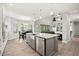 Open-concept kitchen with island, modern lighting, and an adjacent dining area at 17648 Live Oak Dr, Tavares, FL 32778