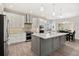 Spacious kitchen with white cabinets, a marble island, and stainless steel appliances at 17648 Live Oak Dr, Tavares, FL 32778