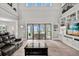 Bright living room with a fireplace, a built-in bookshelf, and sliding doors leading to the outdoor patio at 17648 Live Oak Dr, Tavares, FL 32778
