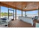 Covered and screened in outdoor seating area with views of the lake at 17648 Live Oak Dr, Tavares, FL 32778