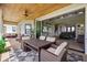 Outdoor patio with a dining set, plush cushions, and a view to the interior of the home at 17648 Live Oak Dr, Tavares, FL 32778