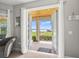 View from interior through patio doors to a covered patio and scenic lake view at 17648 Live Oak Dr, Tavares, FL 32778