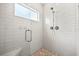 Modern bathroom with a glass-enclosed shower featuring tile walls and a corner bench at 17648 Live Oak Dr, Tavares, FL 32778