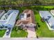 Aerial view of a home with a pool, surrounded by well-maintained landscaping in a residential neighborhood at 17728 Se 115Th Ct, Summerfield, FL 34491