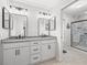 Updated bathroom features double sinks with granite counters and an updated glass enclosed tile shower at 17728 Se 115Th Ct, Summerfield, FL 34491
