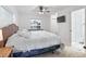 Bright bedroom with a ceiling fan, tv, large bed, and view of the neighborhood at 17728 Se 115Th Ct, Summerfield, FL 34491