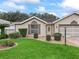 Attractive home with a well-kept lawn, brick driveway, and inviting entrance at 17728 Se 115Th Ct, Summerfield, FL 34491