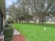 Well-manicured front yard with mature trees and lush green grass at 17728 Se 115Th Ct, Summerfield, FL 34491