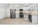 Well-equipped kitchen boasting stainless steel appliances, granite countertops, and modern cabinetry at 17728 Se 115Th Ct, Summerfield, FL 34491